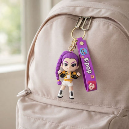 Keychain with a character rumi and 'KPOP' strap attached to a beige backpack.

