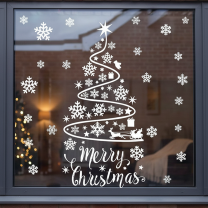White snowflake and Christmas tree cutout stickers on glass window with Merry Christmas text festive holiday decoration